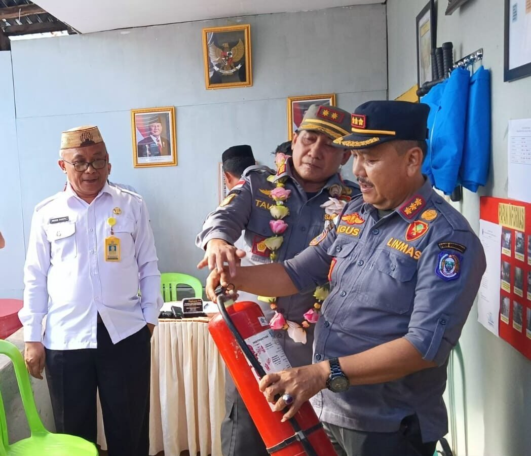 Kasatpol PP Provinsi Gorontalo Taufik Sidiki dan Kabid Linmas dan Damkar Provinsi Gorontalp, Agus Maliki Memperagakan Alat Pemadam Kebakaran. (Foto: annahdlah)